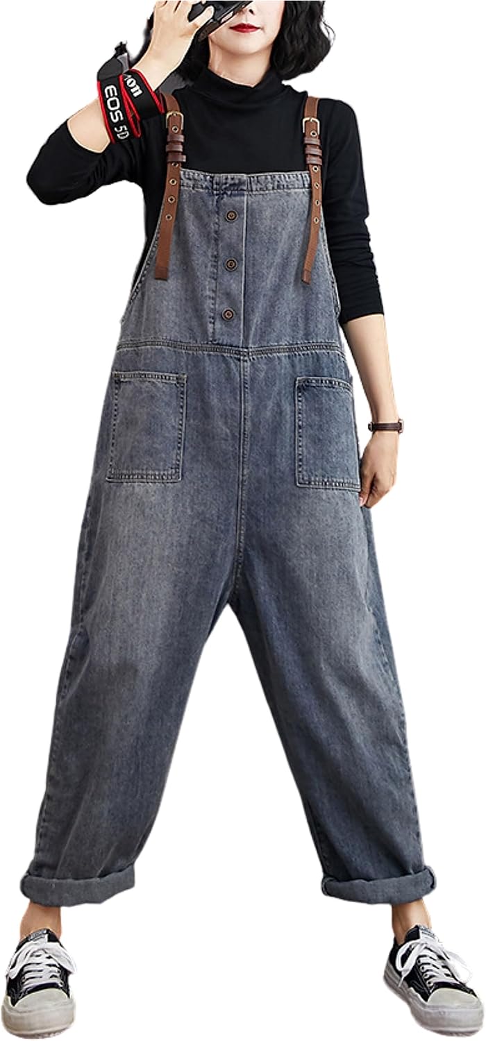 Person wearing denim overalls with brown straps on a white background