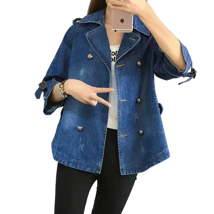 Person wearing a blue denim jacket pointing at themselves on a white background